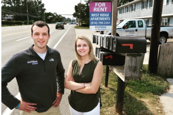 Paul and Christine Hoffman standing in front of West Ridge Apartments